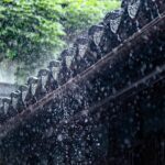 Rain falls over a traditional Chinese roof, capturing the essence of summer showers.